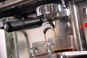 Espreesso coffee pouring from coffee machine