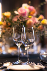 empty wine glasses set up on vibrant flower decor table