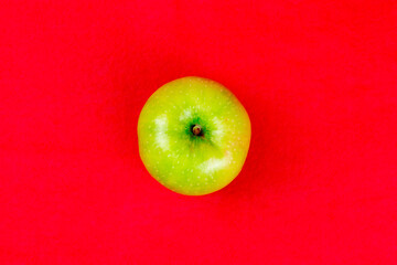 Green apples on a red background