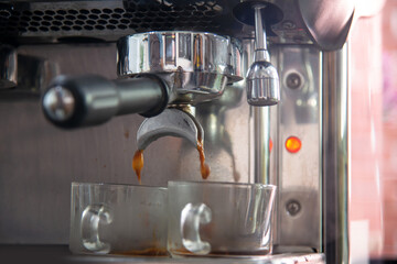 Espreesso coffee pouring from coffee machine