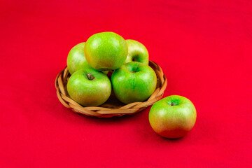 Green apples on a red background