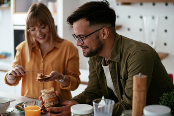 Young couple making delicious food at home. Loving couple enjoying in the kitchen..