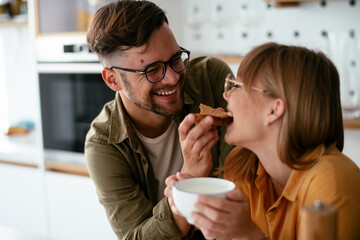 Young couple making delicious food at home. Loving couple enjoying in the kitchen..