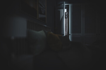 Demon in the wardrobe - spooky horror scene for halloween