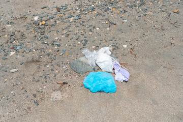 Medical waste, face mask discarded garbage, kids play on sea beach, COVID-19 virus pandemic pollution