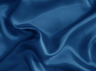 Shiny blue crumpled fabric. Wavy cloth background