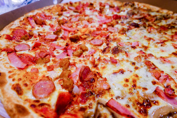 Closeup of Italian pizza. Tasty pepperoni pizza and cooking ingredients. Half pepperoni half mushroom