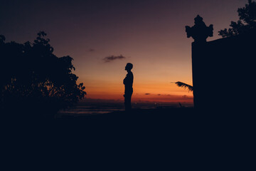 Fototapeta premium Unrecognizable silhouette of woman in twilight