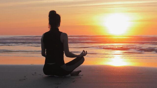 Silhouette of woman on the beach, Practice of yoga