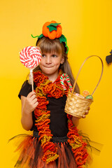 Little girl collecting candies for Halloween trick or treat