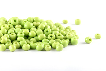 Close up of Light green Beads on the white background. Background or texture of beads. macro,It is used in finishing fashion clothes. make bead necklace or string of beads for woman of fashion.