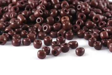 Close up of brown Beads on the white background. Background or texture of beads. macro,It is used in finishing fashion clothes. make bead necklace or string of beads for woman of fashion.