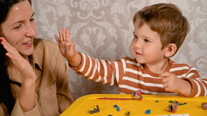 child gives five to mother