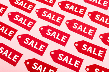 top view of labels with sale lettering on pink, black friday concept
