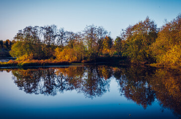 autumn trees reflected in lake