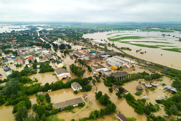 Fototapeta na wymiar Aerial view of flooded houses with dirty water of Dnister river in Halych town, western Ukraine.