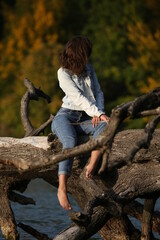 young girl on a withered tree