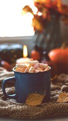 Autumn background with dry leaves, blue cup of coffee. Knitted background, pumpkins, October, November. Autumnal atmosphere. Autumn season.