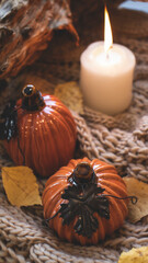 Autumn background with dry leaves, blue cup of coffee. Knitted background, pumpkins, October, November. Autumnal atmosphere. Autumn season.