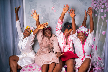 Group of happy African women wearing bath robes with pink design background-concept on black breast cancer awareness or campaign.