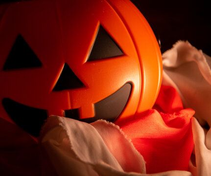 Orange pumpkin smiling on a terrorific background
