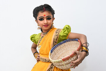 Beautiful Indian girl or women or kid wearing sari or saree as Indian folk, classical dancer in dance pose wearing traditional dress for females in Kerala, India. wearing ornaments and makeup. 