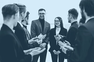 business team congratulating their colleagues with applause