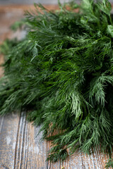 Close up of fresh dill bouquet, laying on wooden kitchen table