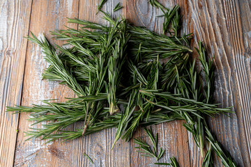 Rosemary heap, close up on wooden background, catalogue photoshoot