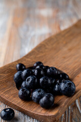 Close up of big blueberries in a wooden spoon