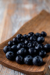 Close up of big blueberries in a wooden spoon