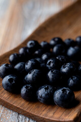 Close up of big blueberries in a wooden spoon