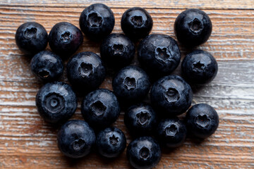 Ripe blueberries on wooden background, close up, appetizing advertisement and catalog shot