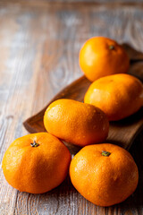 Tangerine pile on a wooden table close up