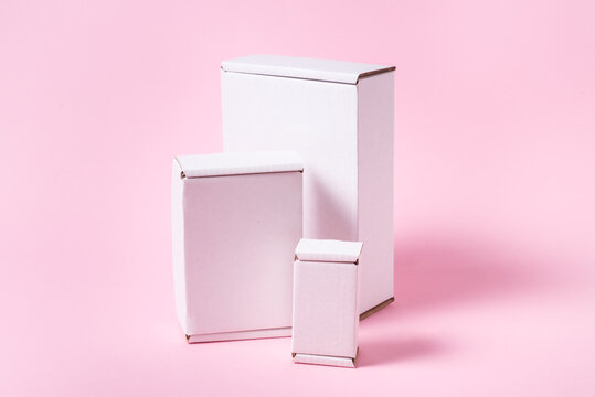 Set of white cardboard, carton flat boxes on pink background