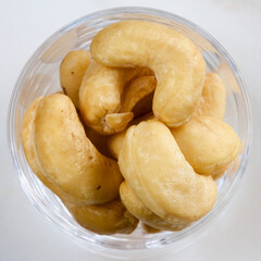 Cashew nuts in a glass dish.