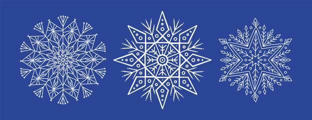 White openwork snowflakes with small details on a blue background are isolated. Line and decorative elements for New Year, Christmas design on a dark background isolated. Christmas sale