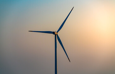 Fototapeta premium Wind turbine generating power in the evening.