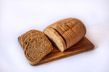 
Bread and buns on the kitchen board. Sliced ​​bread. Appetizing bread in the photo