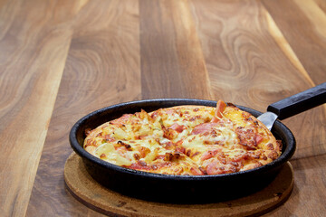 Italian Pizza in chopping board on a wooden table