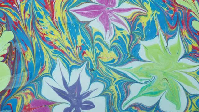 Staining objects with ebru technique. colored paints on water