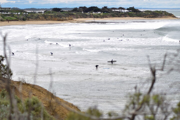 view of people surfing from a cliff