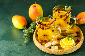 Two glass cup of festive winter drinks, pear cider spice cocktail. Hot drink cocktail for...