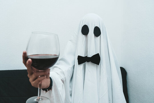 Ghost drinking red wine wearing a formal black bow looking at camera