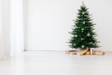 Stylish Christmas scandinavian minimalistic interior Christmas tree with light and bauble in sunny living room