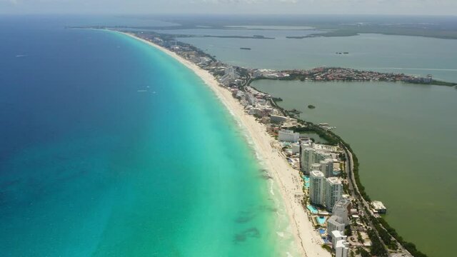 Aerial view of Cancun Hotel zone with turquoise water and white beaches on a sunny day.