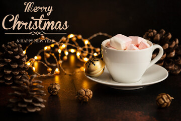 Warm cocoa drink with marshmallows. Christmas and New Year drink. Winter holidays concept with text - Merry Christmas and Happy New Year. Dark background