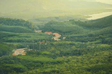 Aerial view of Ranong province with road in green mountain in morning time