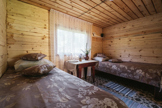 Wooden simple rustic bedroom interior in mountain summer resort