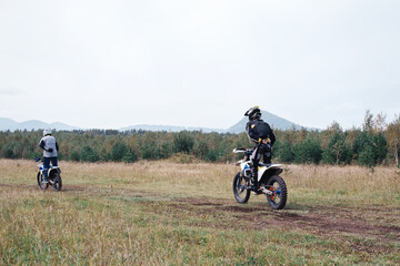 motocross training, man doing exercises driving enduro motorcycles on motordrome